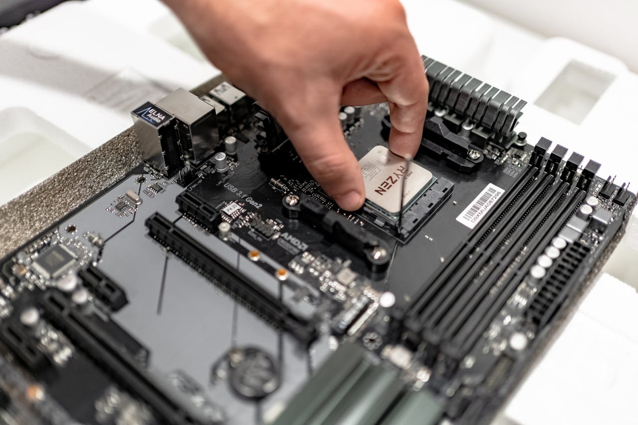 Persons hand installing a CPU on a motherboard, showcasing PC maintenance and repair.